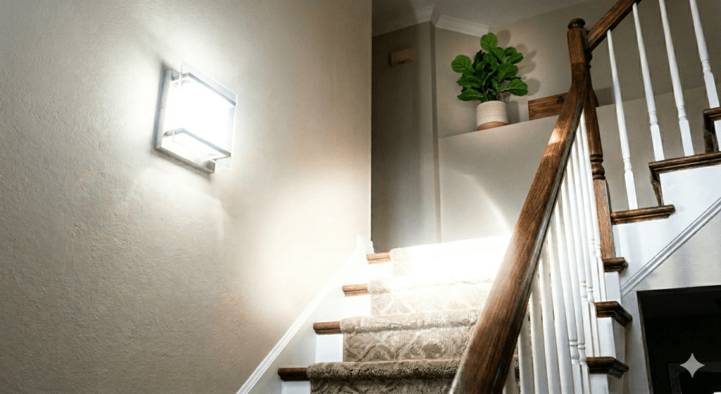 Bright wall light creating glare near a residential staircase
